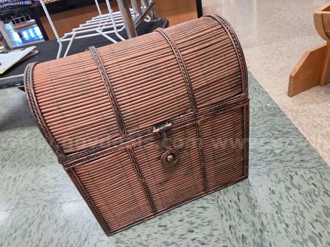 Small wicker trunk with metal handles and latch