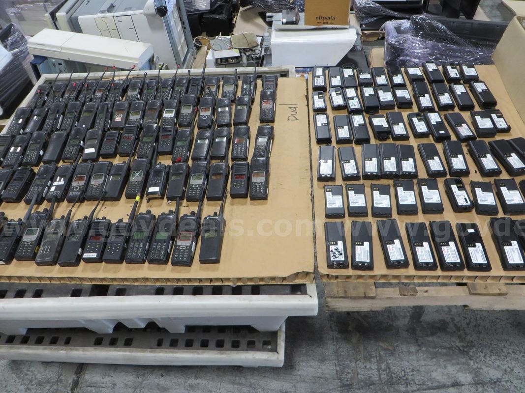 73 Hand-held radios, 69 batteries, and a case of clips.