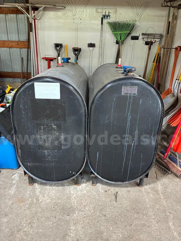 Two  200 gallon bulk oil tanks