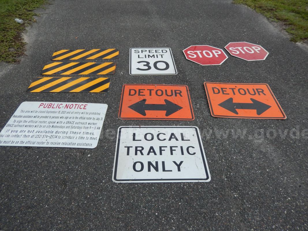 Used (3) Yellow And Black Signs, (2) Detour Signs, (2) Stop Signs, (1) Speed Limit 30 Sign, (1) Local Traffic Only Sign