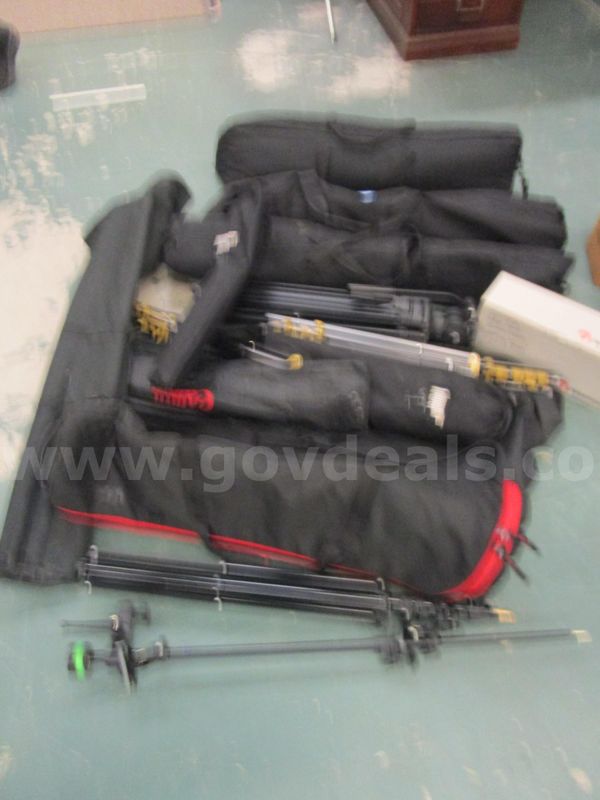 Eleven tripods cases and parts