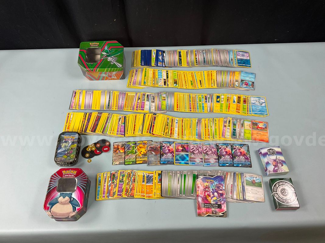 Lot of Pokemon Cards in Pokemon Tins