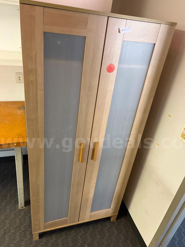 Pale wood closet with ribbed panel doors
